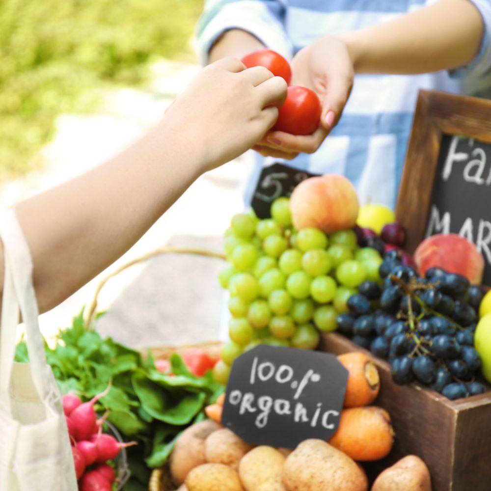 Buying organic fruits at a fresh produce market.