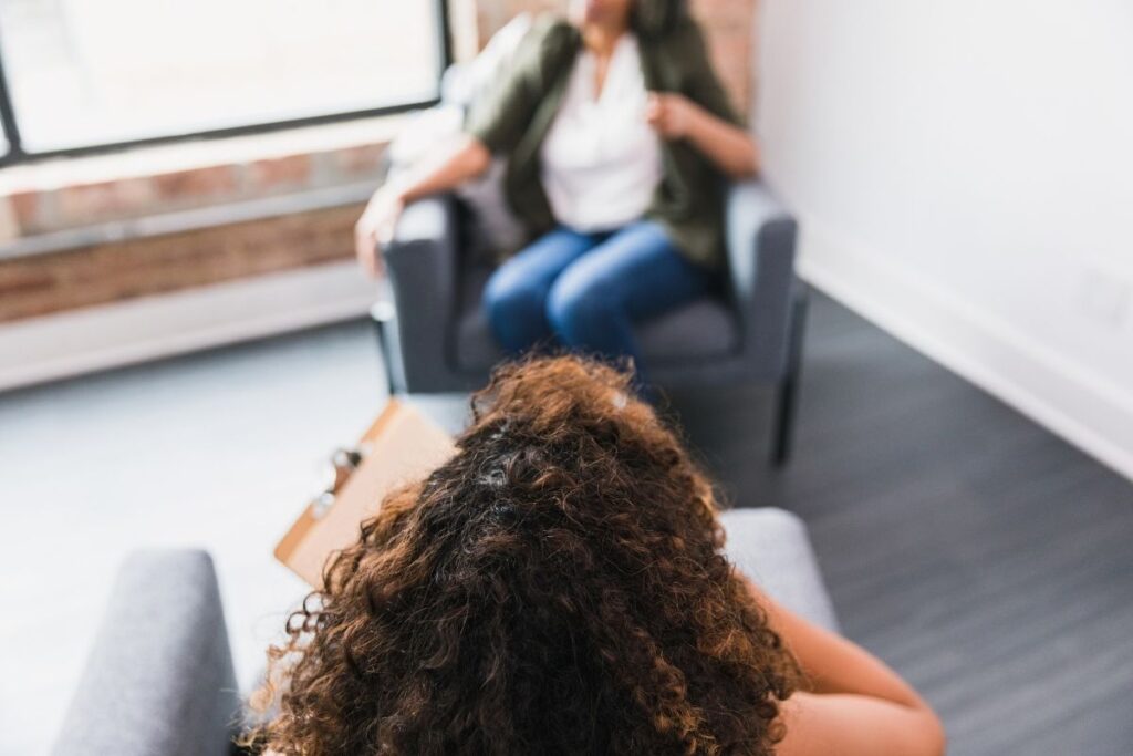 View from behind a therapist as a client talks during a session