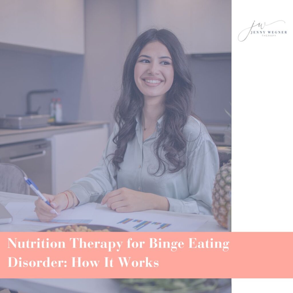 Smiling female nutrition therapist sitting at a kitchen table with charts and fruit