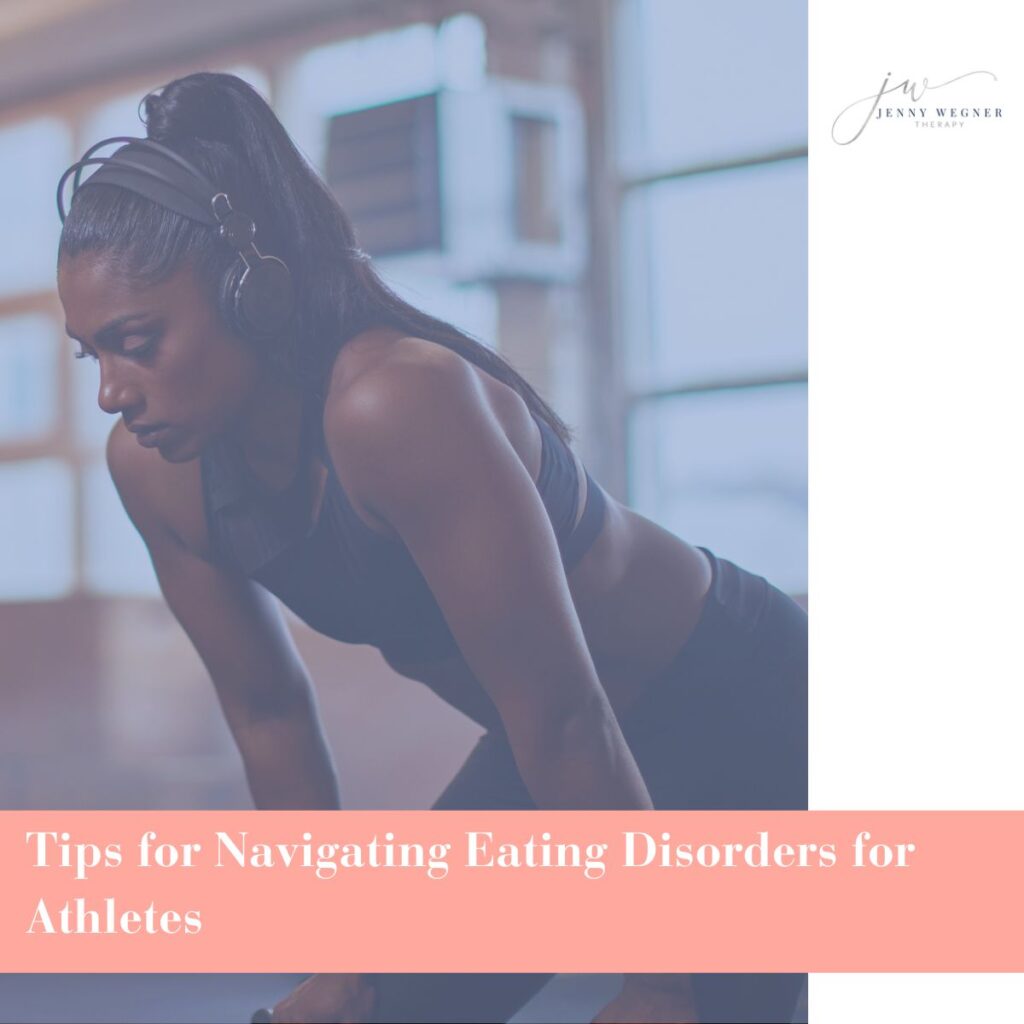 Woman wearing black sportswear and headphones leaning on gym equipment inside fitness studio