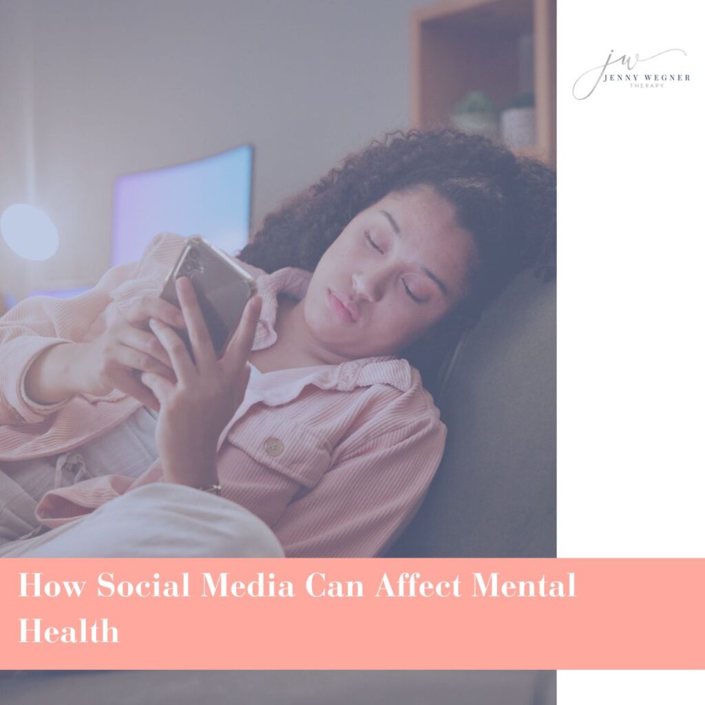 Young woman lying on couch, looking at her phone with a tired and distant expression